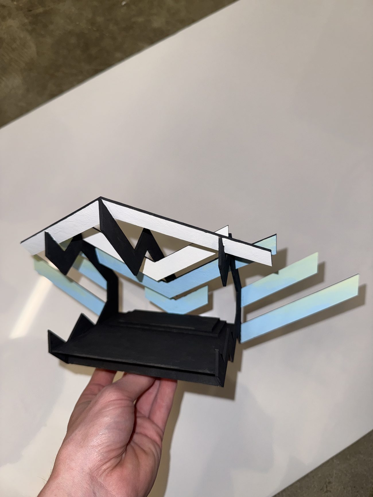 Model in hand, showing the raking legs