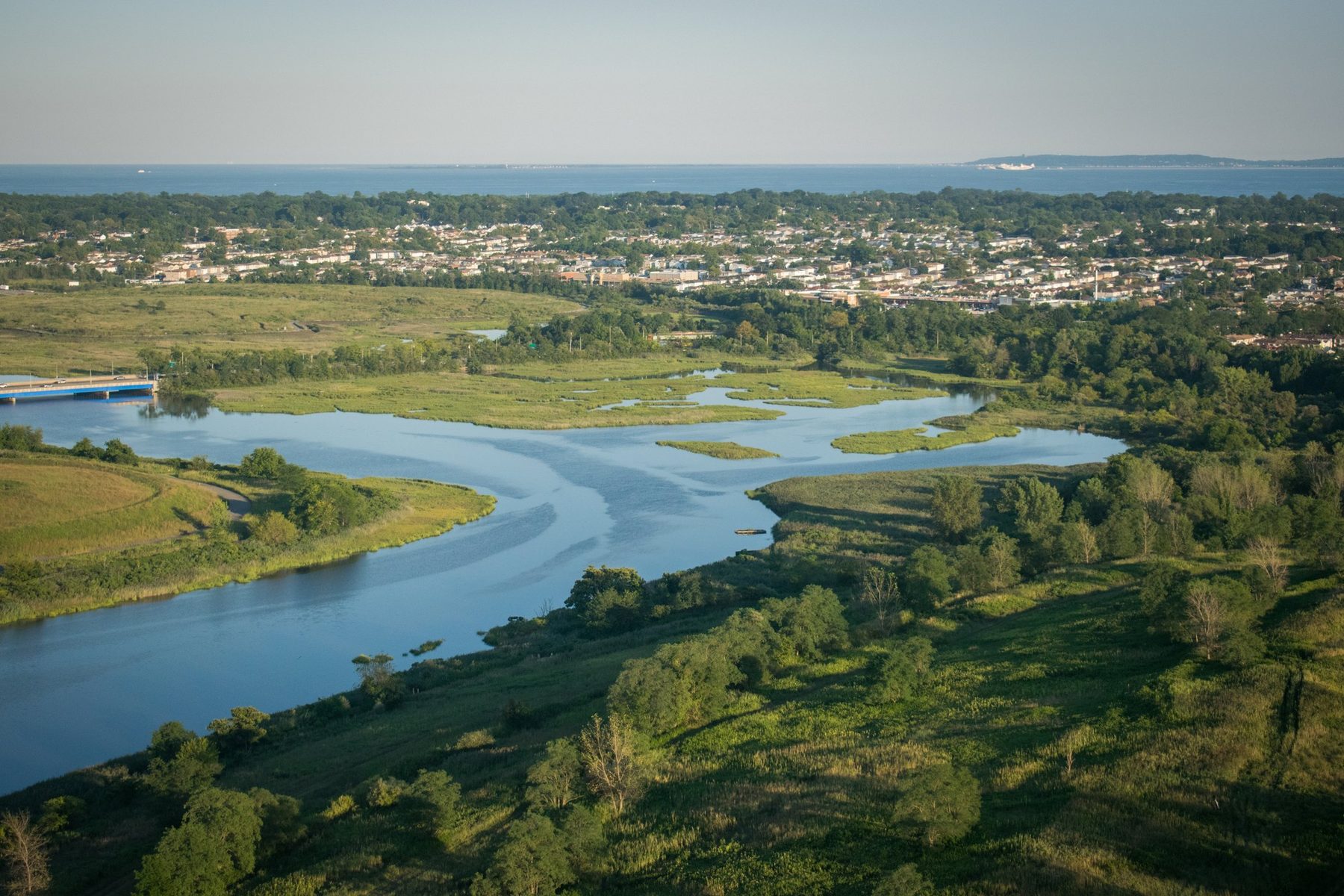 The same ground today: capped mounds and restored tidal creek